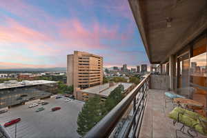 Balcony at dusk with a view of city