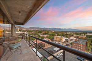 Balcony at dusk featuring a mountain view