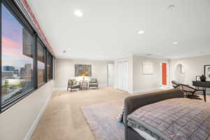 Primary Bedroom with carpet, ornamental molding, recessed lighting, and a closet