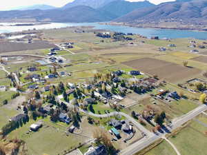 Aerial view of property and surrounding area with a water and mountain view