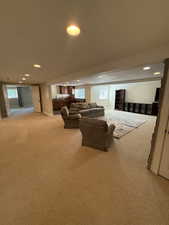 Living room featuring light carpet, recessed lighting, and healthy amount of natural light