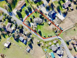 Aerial perspective of suburban area featuring property boundaries highlighted