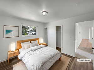 Bedroom featuring wood finished floors and a closet