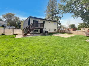 Back of property with a patio, stairs, a gate, and a deck