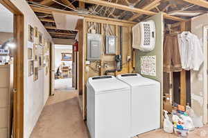 Laundry room with washer / clothes dryer and electric panel