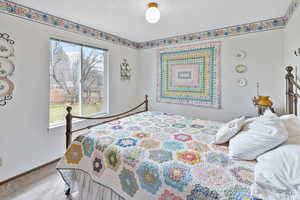 Carpeted bedroom featuring baseboards