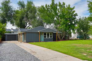 View of front of home with driveway, board and batten siding, and an attached garage