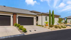 View of front of home featuring stucco siding, driveway, an attached garage, and a tiled roof