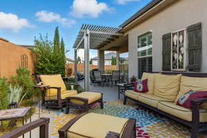 Fenced backyard with an outdoor living space, a pergola, a patio area, and outdoor dining area