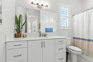 Bathroom featuring vanity and a shower with shower curtain
