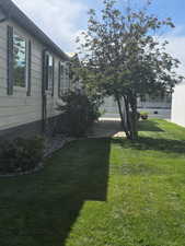 View of grassy yard featuring a garage