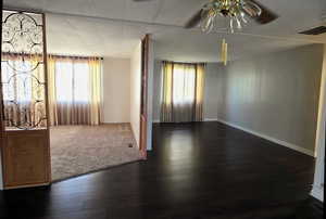Great Room/Office featuring healthy amount of natural light, dark wood-type flooring, and a ceiling fan