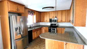 Brand New "Martha Stewart" Kitchen featuring a nice bar, stainless steel appliances, and brown cabinets
