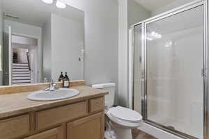 Full bathroom with vanity and a shower stall