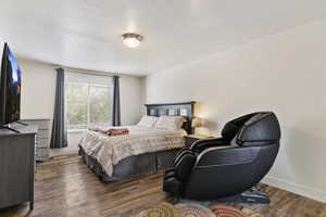 Bedroom featuring wood finished floors and baseboards