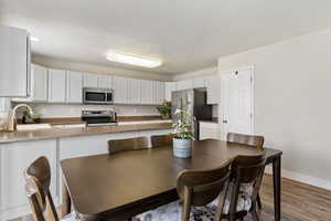 Dining area featuring wood finished floors and baseboards