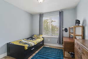 Bedroom featuring light wood-style flooring and baseboards