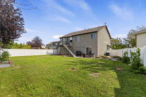 Back of house with a patio area, stairs, a fenced backyard, and a deck