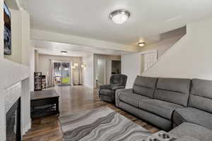 Living room featuring wood finished floors and a tiled fireplace