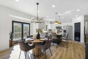 Dining room featuring light wood-style floors, recessed lighting, and a chandelier