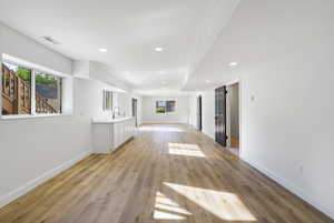 Interior space with white cabinets, light countertops, recessed lighting, and light wood-style flooring