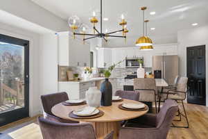 Dining room featuring recessed lighting, light wood finished floors, and a chandelier