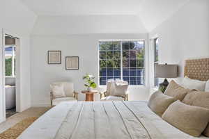 Bedroom featuring carpet floors and lofted ceiling