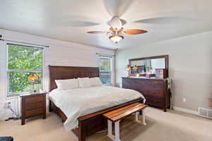 Bedroom with light carpet and ceiling fan
