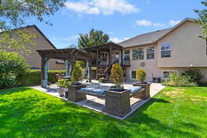 Rear view of property with a patio area, stairway, a pergola, stucco siding, and a yard