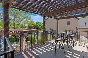 View of patio / terrace with outdoor dining area, a pergola, and a wooden deck