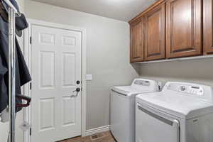 Laundry room with cabinet space and separate washer and dryer