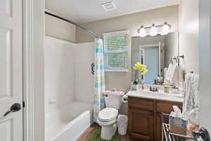 Full bathroom featuring shower / tub combo, vanity, and dark tile patterned flooring