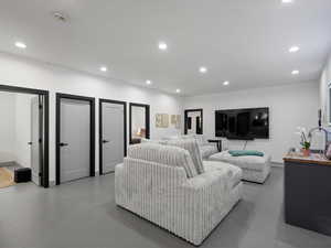 Living room featuring concrete flooring and recessed lighting