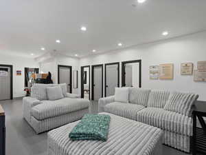Living room with recessed lighting and finished concrete floors