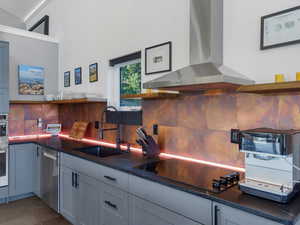 Kitchen featuring open shelves, backsplash, wall chimney exhaust hood, stainless steel appliances, and white cabinets