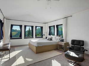 Bedroom featuring carpet, vaulted ceiling, and a ceiling fan