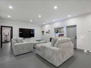 Living room featuring concrete flooring and recessed lighting