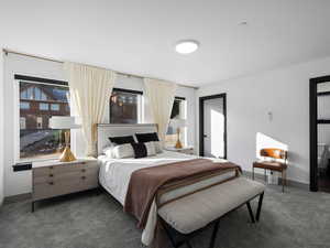 Bedroom featuring carpet floors and baseboards