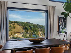 Dining area with view of wooded area