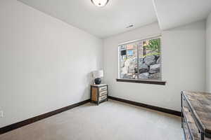 Carpeted empty room with baseboards