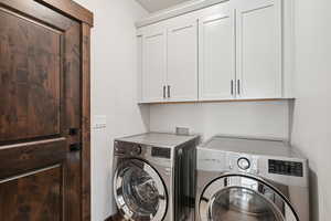 Laundry area with separate washer and dryer and cabinet space