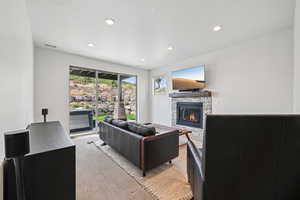 Carpeted living area featuring a fireplace and recessed lighting
