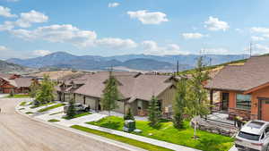 View of mountain backdrop featuring nearby suburban area