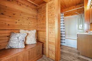 Mudroom featuring wood finished floors and wood walls