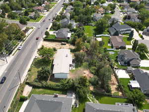 Aerial view of property and surrounding area featuring nearby suburban area