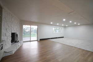 Unfurnished living room featuring a fireplace, light wood-type flooring, and recessed lighting