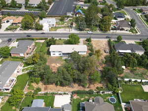 Aerial view of property and surrounding area featuring nearby suburban area