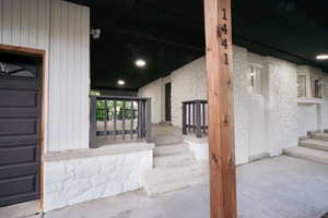 Doorway to property featuring stone siding