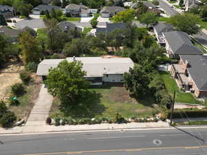Aerial view of property and surrounding area with nearby suburban area