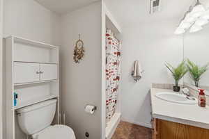 Bathroom with vanity and a stall shower